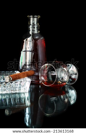 Glass and bottle with cognac and cigar