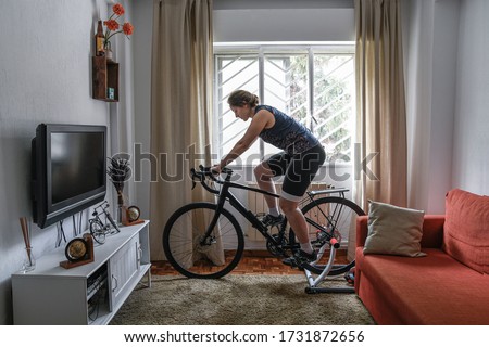 Similar – Image, Stock Photo Female cyclist stretching legs on street