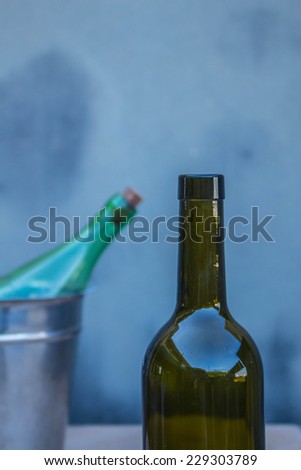 Wine bottle and ice bucket in background