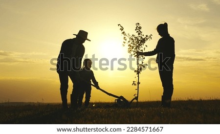 Similar – Foto Bild Mann pflanzt Baum mit Sparten im Garten