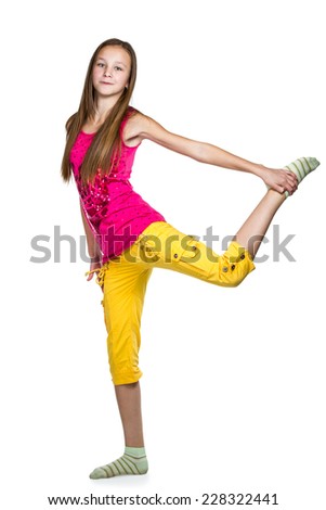 Young girl in red shirt and yellow shorts with long hair doing fitness isolated on white background