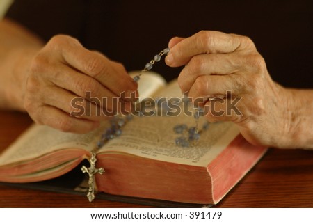 Elder woman\'s hands counting rosemary beads.