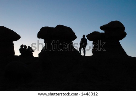 Silhouette of a man in relation to the strange rock formations of Goblin State Park, Utah USA.