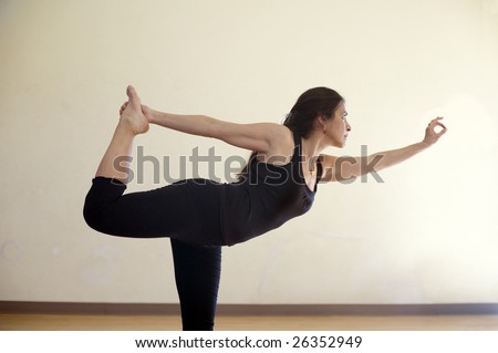 Hispanic woman in the yoga dancer\'s pose Natrajasana. Dedicated to Lord Shiva (Lord of the Dances in Hindu tradition).