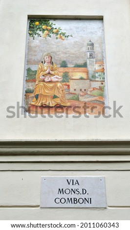 Decorative Painted Plaque on Wall with Italian Street Sign Translated as 'Mister D. Comboni Street'  Photo stock © 