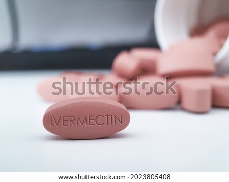 Ivermectin red pill medication on white table medical concept of International nonproprietary name for coronavirus and antiparasitic drug
