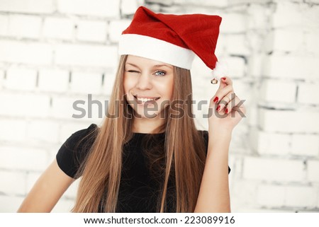 Young pretty woman in red x-mas hat smiling
