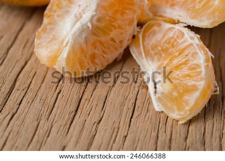 Close-up of orange fruit on old wooden board