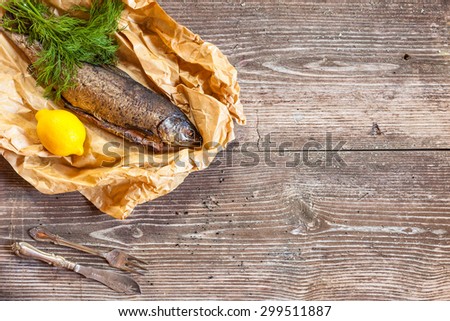Smoked salmon with lemon on rustic wooden table, top view, copyspace, cocking background