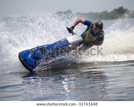 Man on jet ski turns left with much splashes