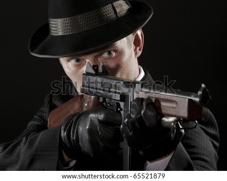 Man aims at submachine gun