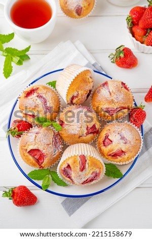 Similar – Image, Stock Photo Eating a strawberry muffin. Woman hands holding a muffin. Fruit dessert