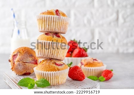 Similar – Image, Stock Photo Eating a strawberry muffin. Woman hands holding a muffin. Fruit dessert