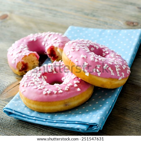Sweet food, pink doughnuts filled with jam square