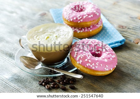 Sweet food, pink doughnuts and cup of coffee with cream