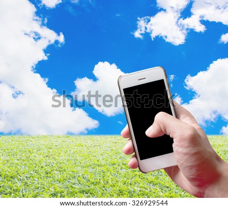 hands holding mobile phone with nature abstract background