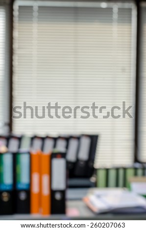 abstract blur background of row of binders in an office archive