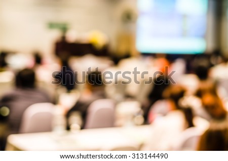 Abstract blurred people in press conference room, business concept, scientific business conference