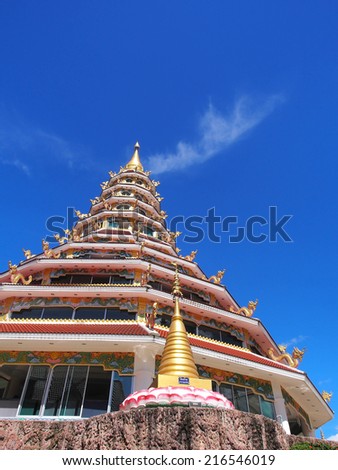 Chinese styled pagoda under blue sky / Pagoda in Thailand temple with contemporary Chinese art under blue sky / Public temple in Thailand was created in Chinese styled