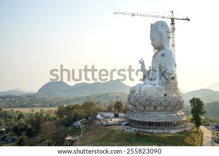 The Goddess of Compassion and Mercy (Guan Yim goddess) constructed giant statue in Thai temple under twilight sky