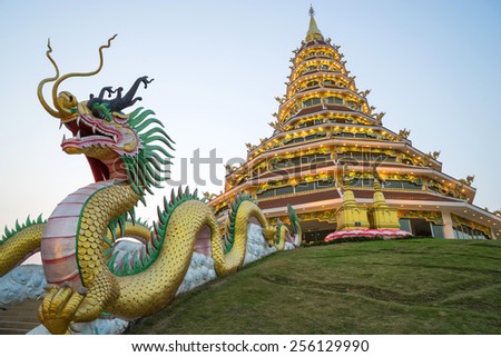 Chinese style nine level pagoda with dragon stairs in Thai temple under twilight sky