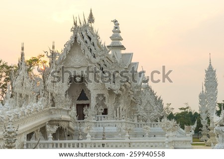 White temple with evening sky is unique beautiful Thai art in Chiangrai