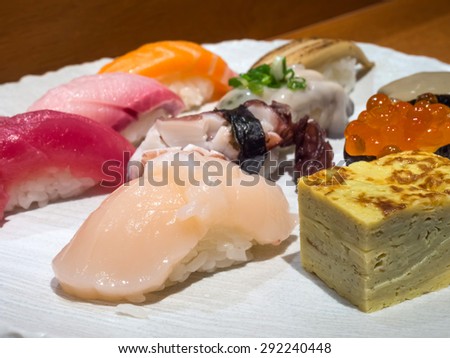 Sushi is authentic luxury delicious Japanese food, made from rice and raw fish, focus on the front piece, raw shell mussel sushi