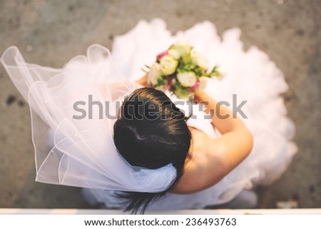 Bride holds flower bouquet view from top