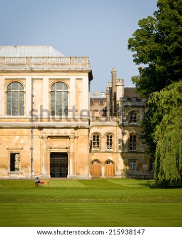 CAMBRIDGE, UK - JUNE 8, 2006: A Cambridge University student sitting on a bench in the gardens of Kings College revises for his studies while enjoying the warmth of the summer sun.