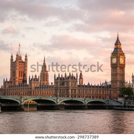 A dusk view over the River Thames, London, of the Palace of Westminster, the seat of UK government.  Big Ben is visible to the right and Westminster Bridge in the foreground.