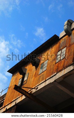 Deserted Rusty Factory Building with Blue Sky