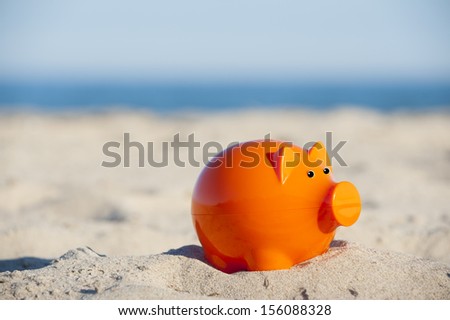 Piggy bank on the beach, conceptual image