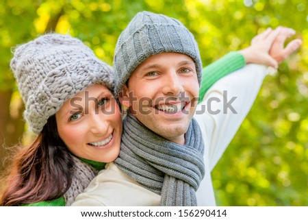 smiling autumn spring couple with outstretched arms