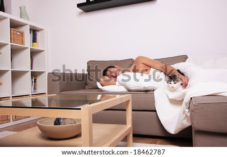 Man sleeping with cat in contemporary home design