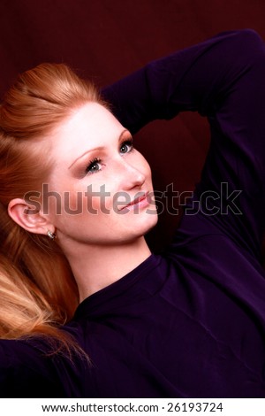 Beautiful redhead girl relaxing arms behind her head