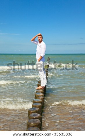 Mans standing in ocean water relaxing and thinking or new business ideas having a interesting vision