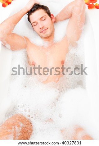 Young guy having a foam bath relaxing