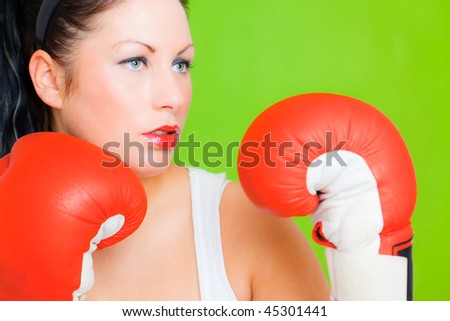 Successful strong fitness woman while box as symbol concept of business emancipation in a men dominating office life
