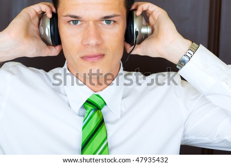 Businessman portrait of young manager listening music