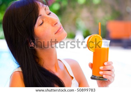 Hotel resort female relaxing drinking cocktail