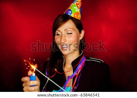 Happy new year celebrating woman holding sparkles