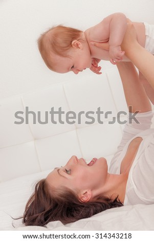 mother flying baby over head