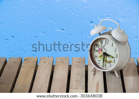 Still Life clock on wooden floor blur background