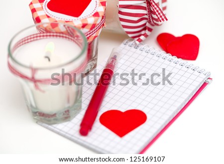 hearts, notebooks and candles over white