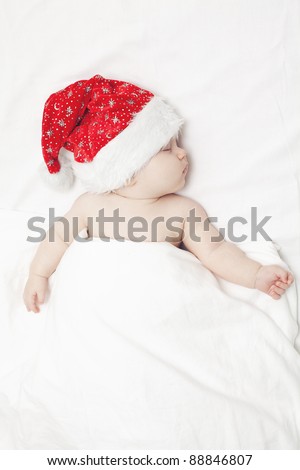 sleeping baby in Santa\'s hat