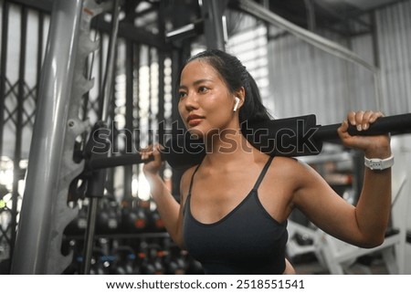 Similar – Image, Stock Photo Focused sportswoman doing squats with elastic band in apartment