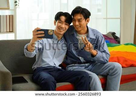 Similar – Image, Stock Photo Cheerful gay couple taking selfie on smartphone