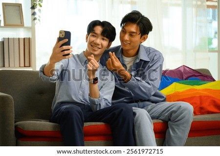 Similar – Image, Stock Photo Cheerful gay couple taking selfie on smartphone