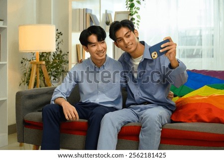 Similar – Image, Stock Photo Cheerful gay couple taking selfie on smartphone