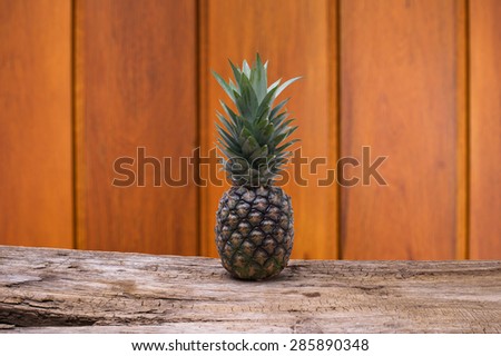 Pineapple on wooden and wood background with clipping part